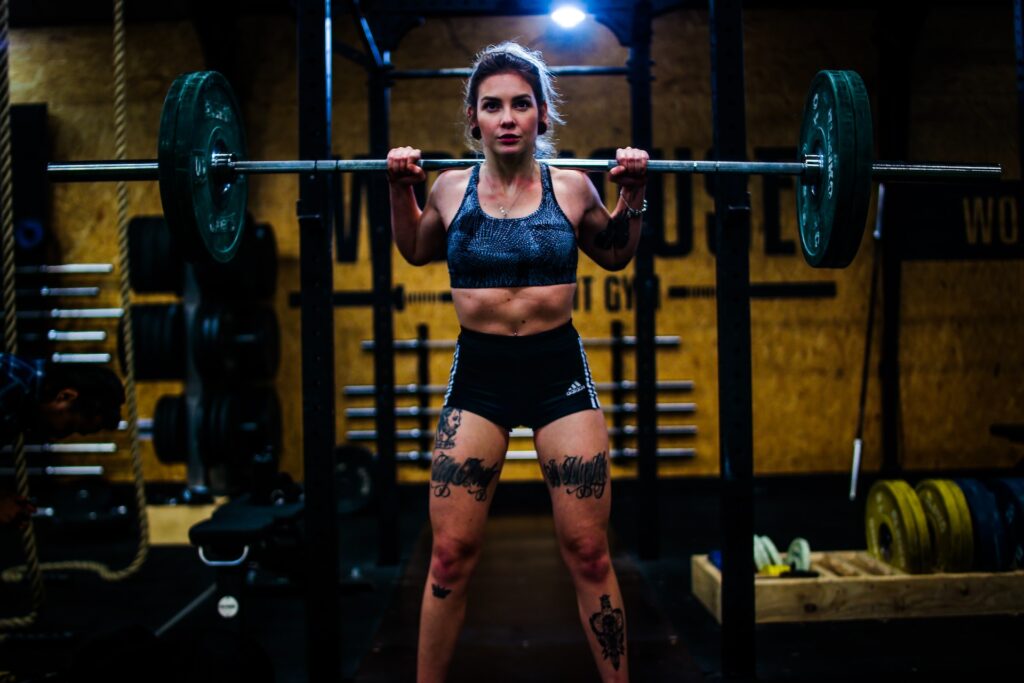 Woman ready to squat with joints purposely out of alignment.
