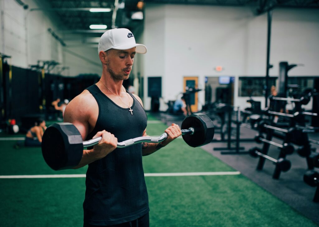 Person using the method of isolation lifts before compound lifts
