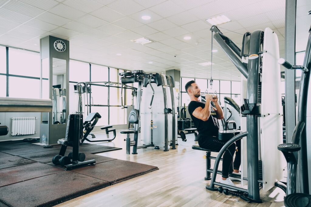 Man using a d-handle like cable attachment for lat pull downs